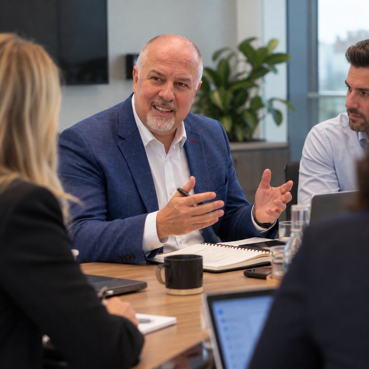 Martyn Pointer leading a discussion around a boardroom table