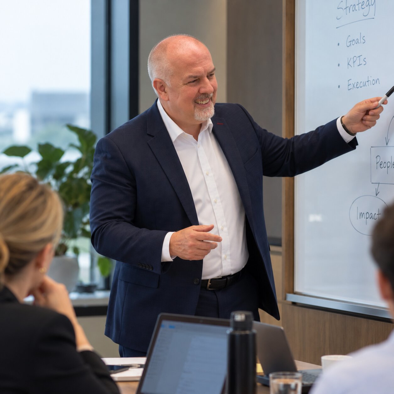 Martyn Pointer mapping business strategy on a whiteboard with a team